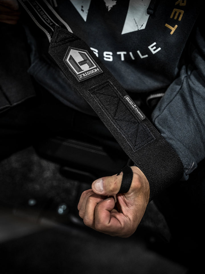 Bodybuilder wearing Hosstile Normal Strength Wrist Wraps for bodybuilders and weight lifters