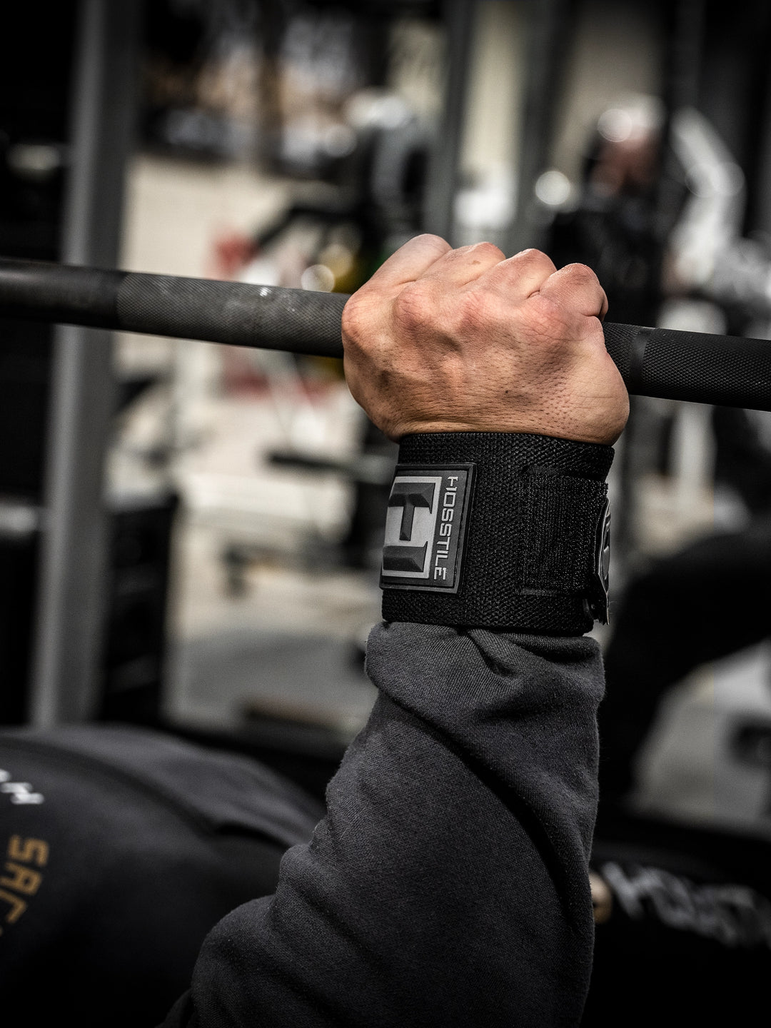 Bodybuilder wearing Hosstile Normal Strength Wrist Wraps for bodybuilders and weight lifters