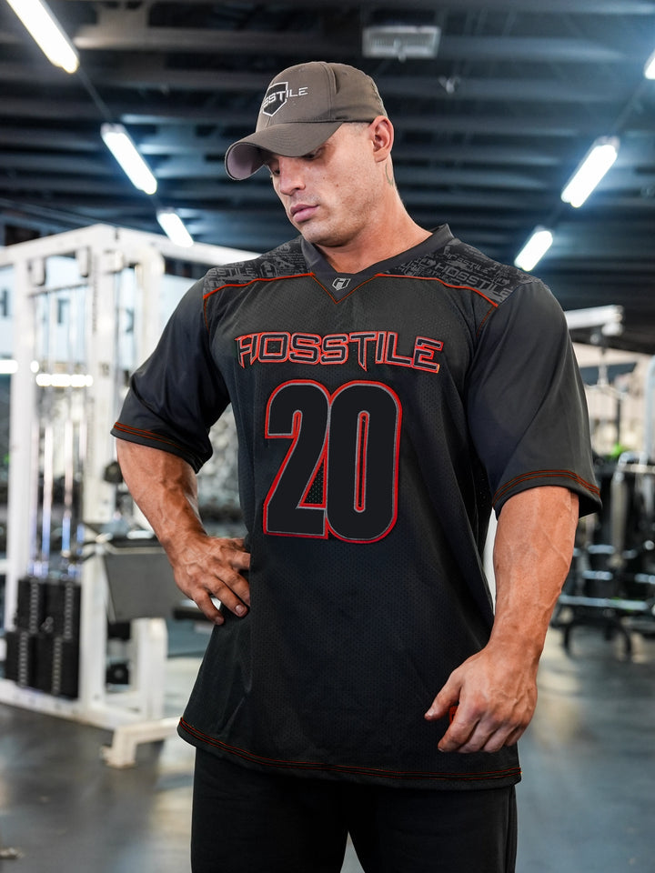 Bodybuilder Martin Fitzwater wearing the Hosstile Olympia Jersey in the Gym#color_black-red