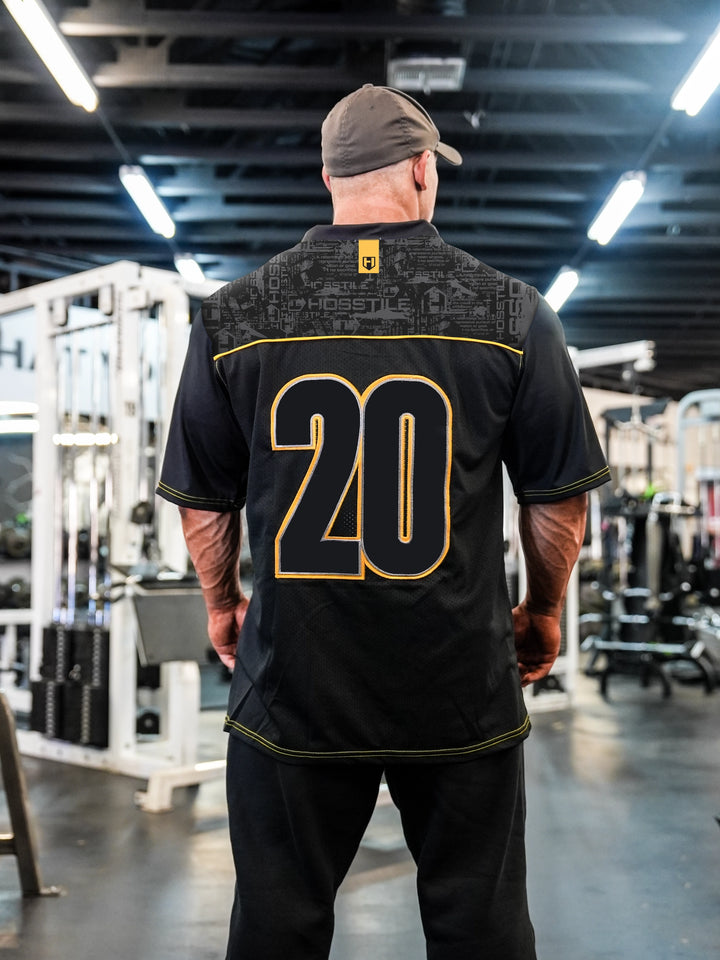 Bodybuilder Martin Fitzwater wearing the Hosstile Olympia Jersey in the Gym#color_black-yellow