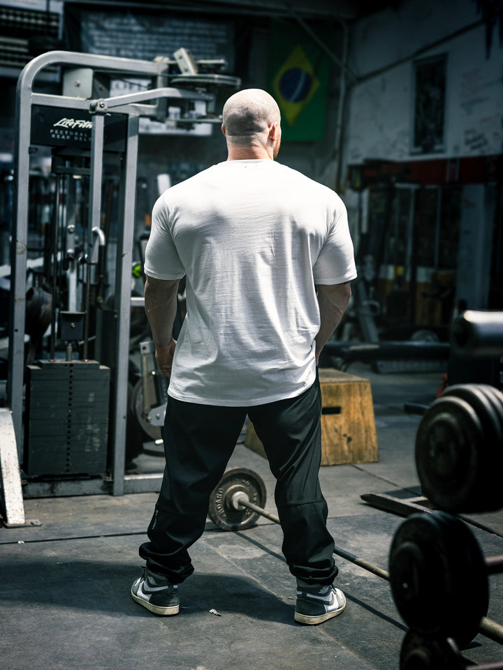 Bodybuilder Martin Fitzwater wearing the Mr. Olympia #19 Samson Dauda t-shirt in the gym#color_white